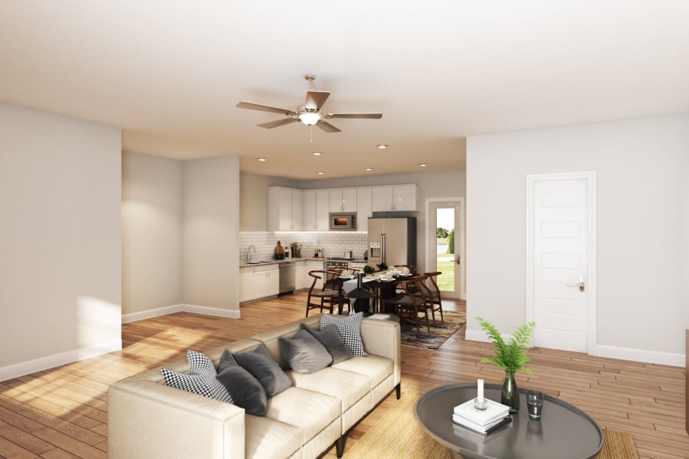 Rendering of the living room area with wood style flooring and a ceiling fan at The Guild in Chattanooga, Tennessee