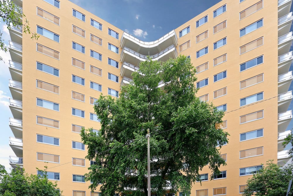 Exterior view of the apartments and the beautiful trees surrounding it at Pembroke Towers in Norfolk, Virginia