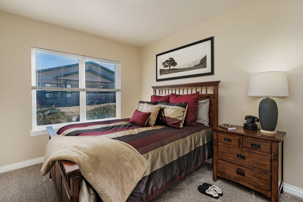 Rustic bedroom in upscale senior apartment with wood accents at The Springs at Grand Park in Billings, Montana