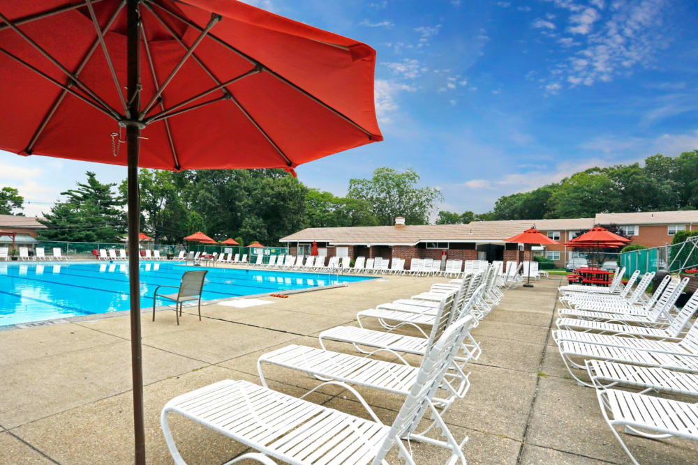 Lounge chairs all the way down the side of the resort style pool at Glenwood Apartments in Old Bridge, New Jersey