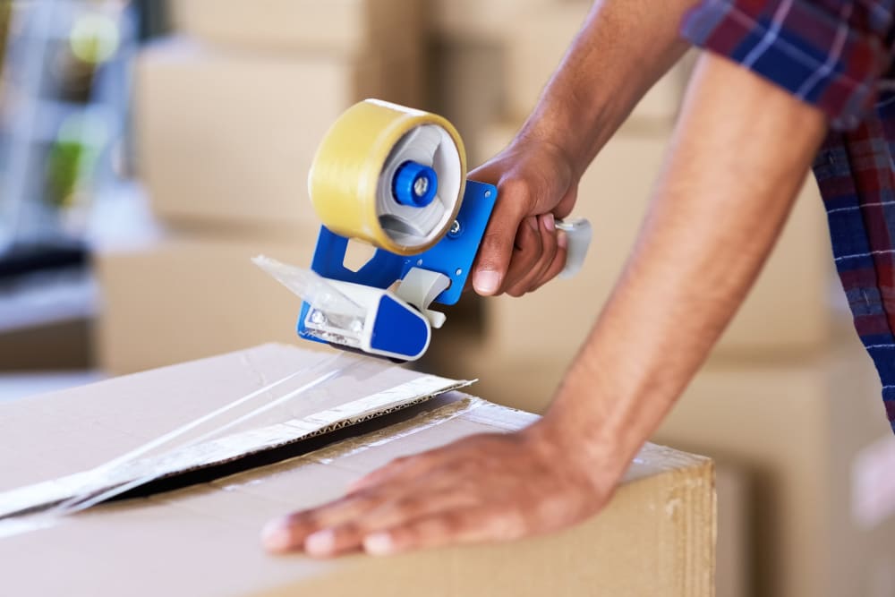 Sealing packed boxes for storage at 603 Storage - Candia in Candia, New Hampshire