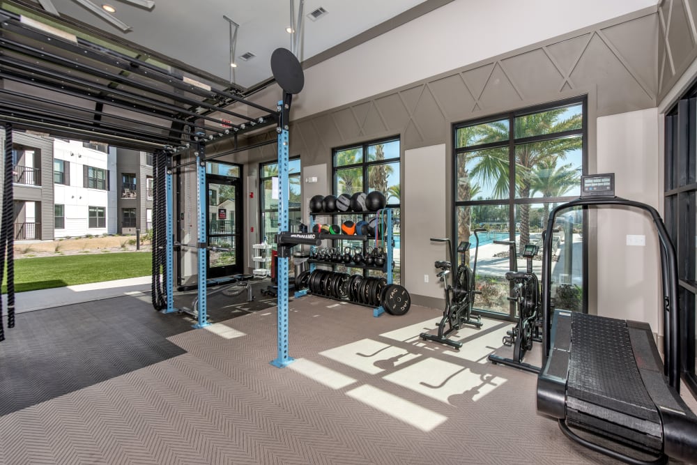 A fitness center with a weight rack at Olympus Emerald Coast in Destin, Florida