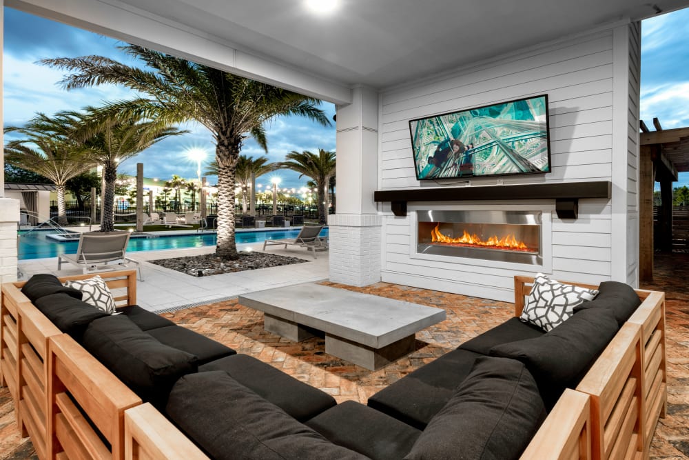 An outdoor lounge with a fireplace at Olympus Emerald Coast in Destin, Florida