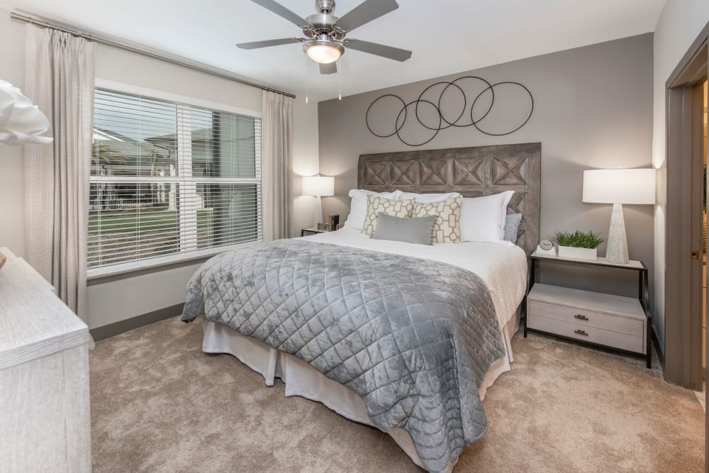 A beautiful primary bedroom in a model home at Olympus Emerald Coast in Destin, Florida