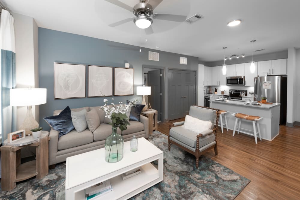 A spacious living room with wood-style flooring at Olympus Emerald Coast in Destin, Florida