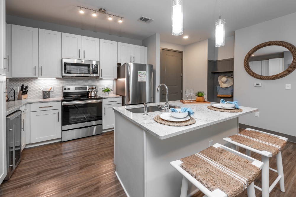 A large kitchen with a breakfast bar for entertaining guests at Olympus Emerald Coast in Destin, Florida