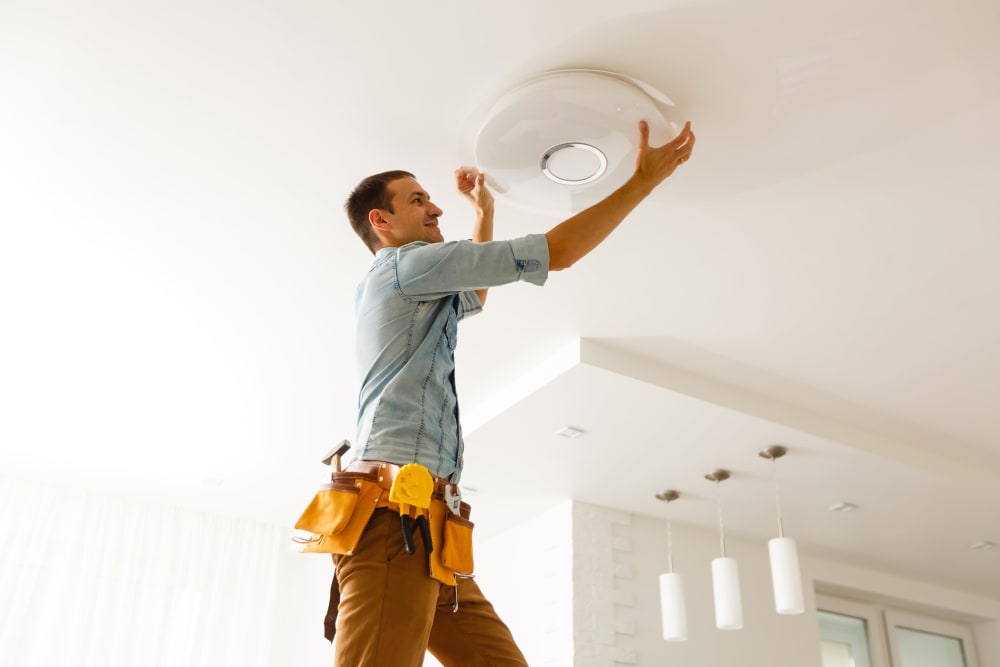 Team member replacing a light bulb near CWS Apartment Homes in Austin, Texas