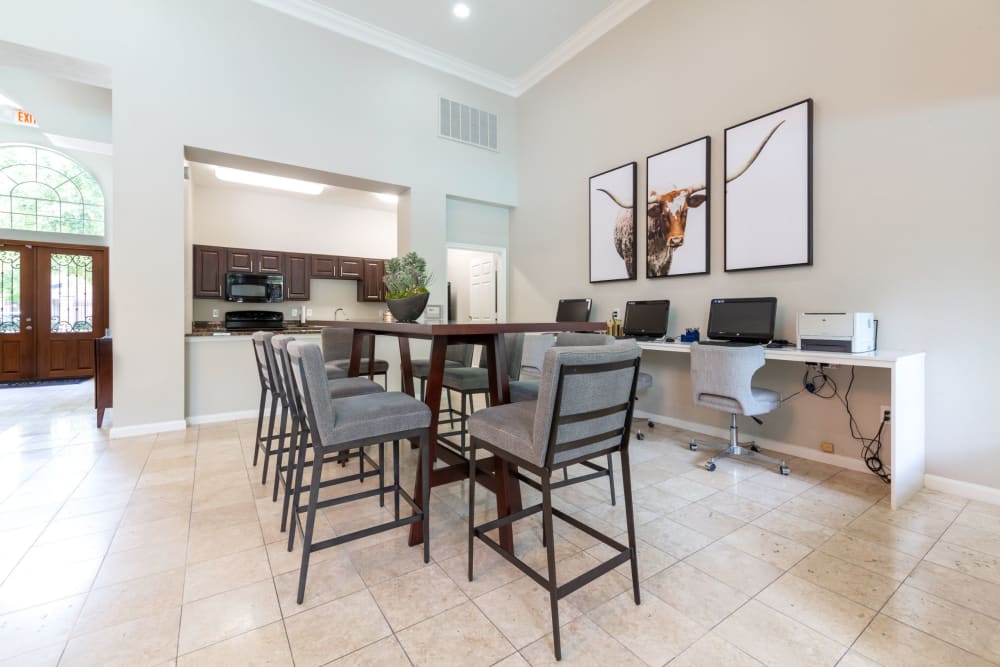 Large table and clubhouse kitchen at at Marquis at Westchase in Houston, Texas