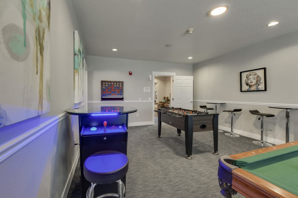 Clubhouse  game room amenities include a pool table foosball and more at The Landings at Morrison Apartments in Gresham, Oregon