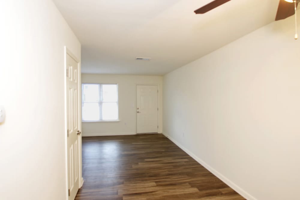 Spacious living room with ceiling fan at Old Mill Townhomes in Lynchburg, Virginia