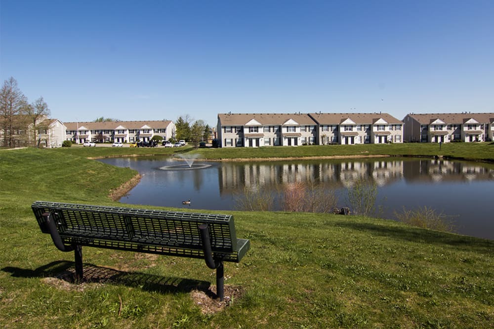 Bench by the lake at Preserve at Sagebrook Apartment Homes in Miamisburg, Ohio