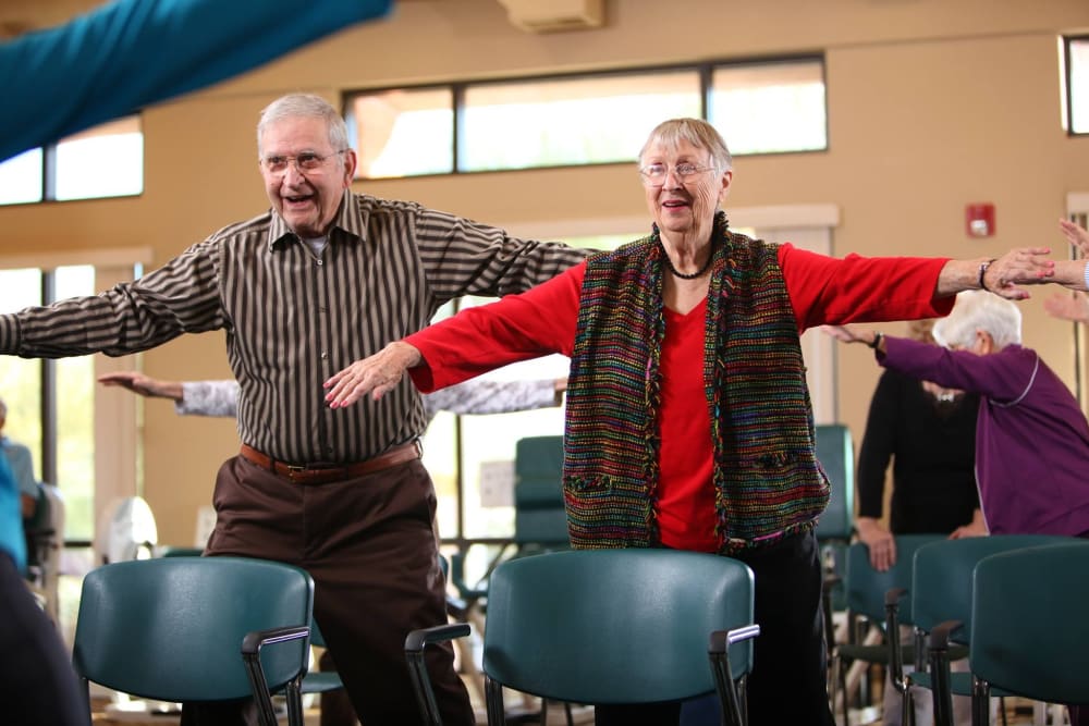 Happy residents participating in exercise class at Brookstone Estates of Charleston in Charleston, Illinois.