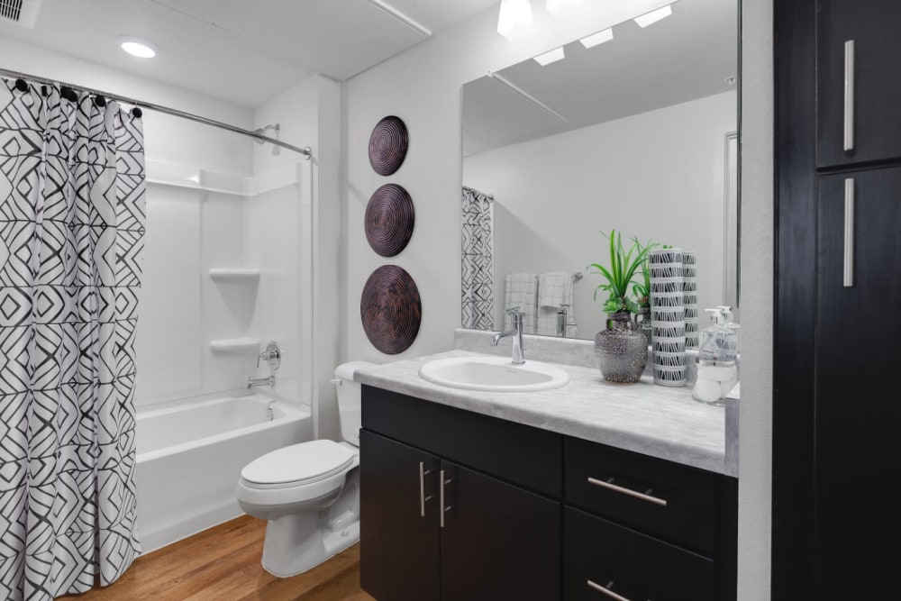 Spacious primary bathroom with a quartz countertop and shower and tub at Olympus Alameda in Albuquerque, New Mexico