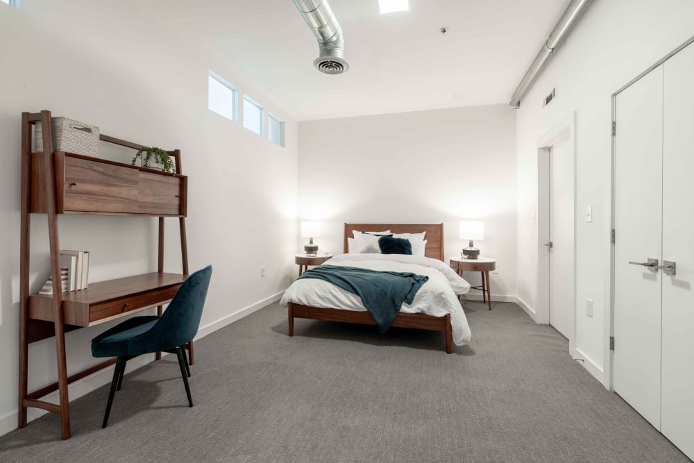 Bedroom with tons of extra space and office desk on the side of the room at 17th Street Lofts in Atlanta, Georgia