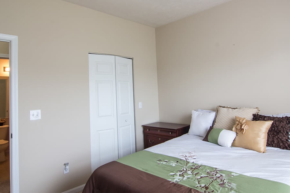 Cozy bedroom at Avalon at Northbrook Apartments & Townhomes in Fort Wayne, Indiana