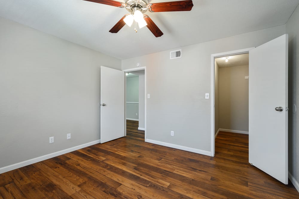 Spacious bedroom with ceiling fan at Windmill Terrace in Bedford, Texas