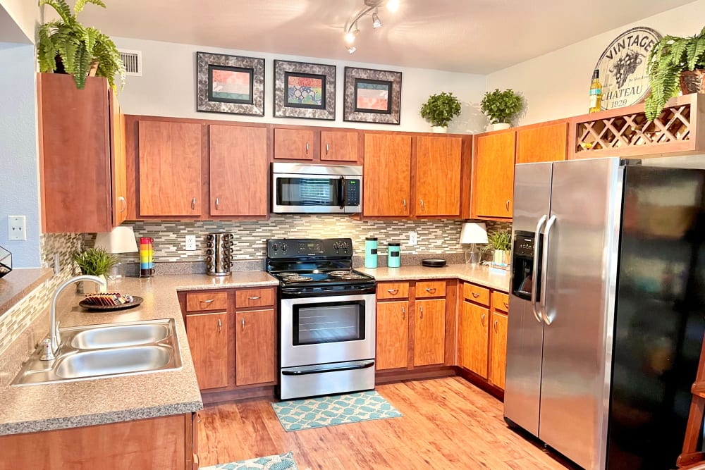 Kitchen with modern appliances at The Abbey at Grant Road in Houston, Texas