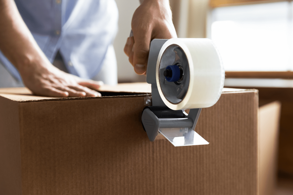 Sealing a box with packing tape at A-American Self Storage in Rialto, California