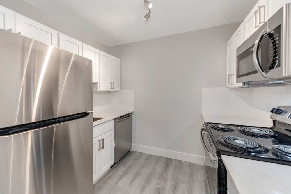Modern looking kitchen with wood style flooring in a new home at The Flats at Arrowood in Charlotte, North Carolina