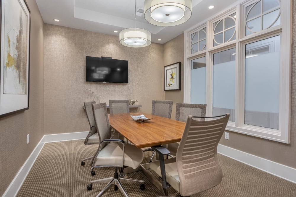 Executive business meeting room with large table and television monitor at Marq at Crabtree in Raleigh, North Carolina