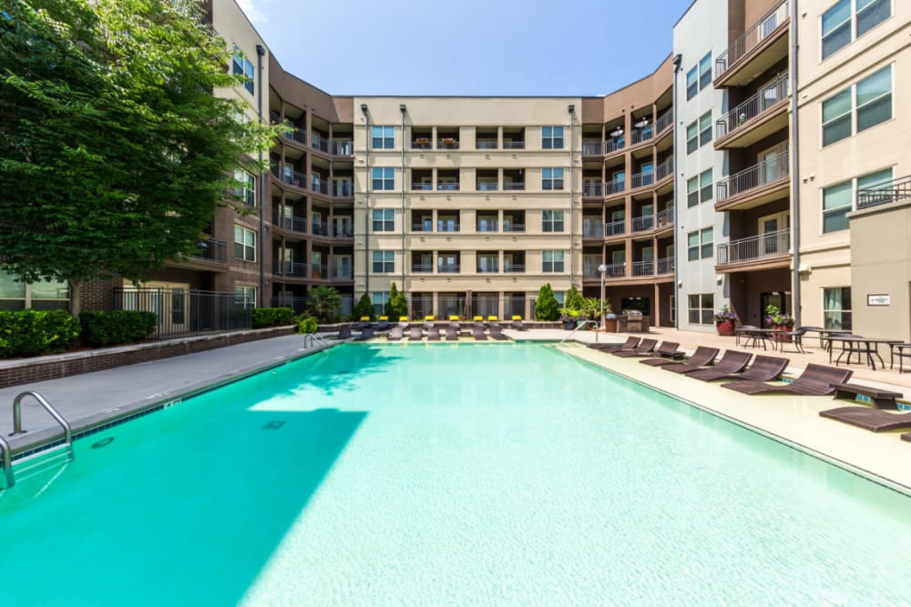 Sparkling pool with lounge chairs in shallow area at Marq Eight in Atlanta, Georgia