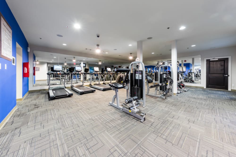 Assisted weight machines with cardio machines in background in fitness room at Marq Eight in Atlanta, Georgia