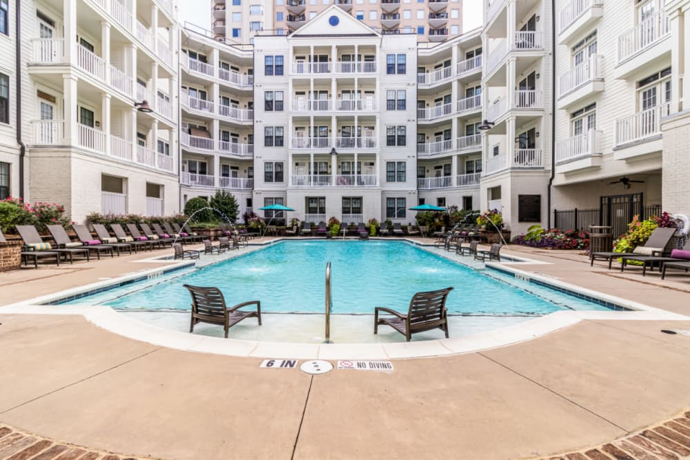 Sparkling resort style pool with chairs in shallow area at Marquis at Buckhead in Atlanta, Georgia