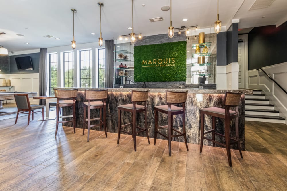 Indoor community room with counter seating and tall counter chairs at Marquis at Buckhead in Atlanta, Georgia