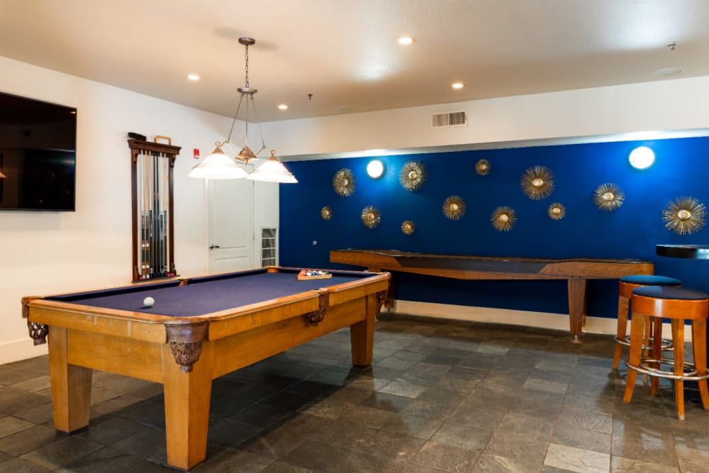 Game room with pool table and shuffle board at Marquis at Texas Street in Dallas, Texas