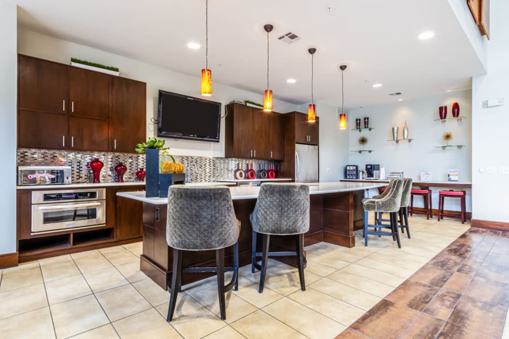Community clubhouse kitchen with counter and counter stools at The Marq on Voss in Houston, Texas