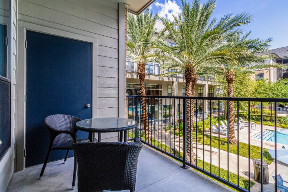 Private balcony with seating area overlooking pool deck at The Marq on Voss in Houston, Texas