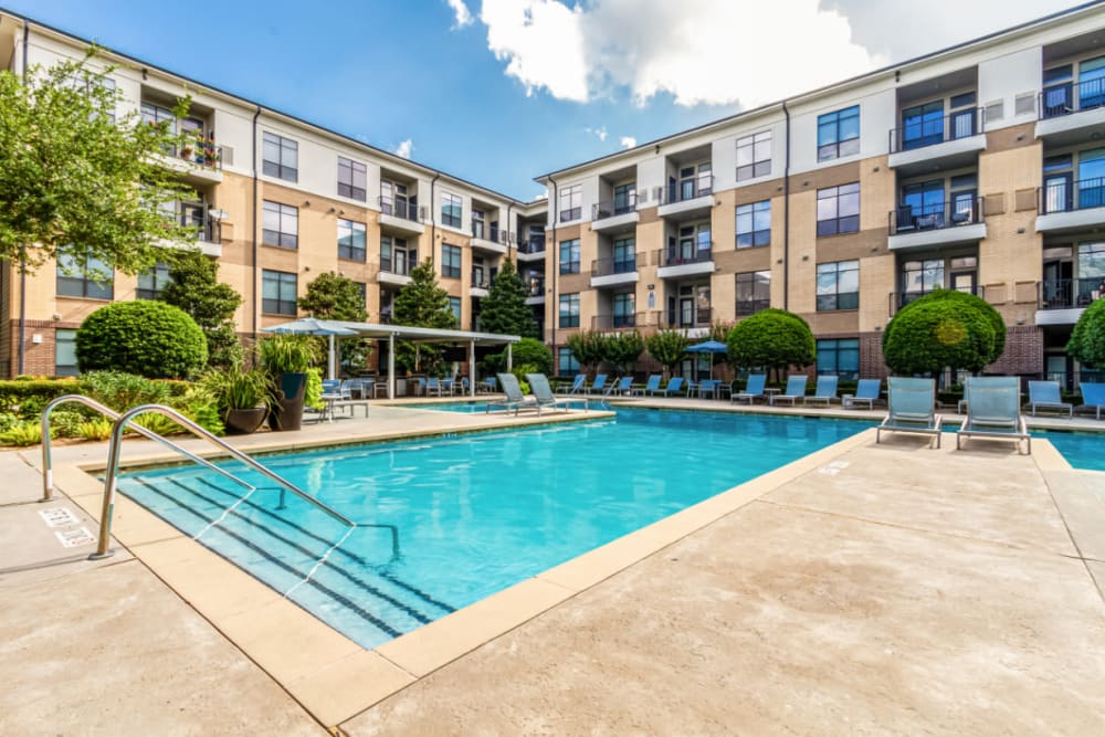 Pool deck with lounge chairs at The Marq on Voss in Houston, Texas