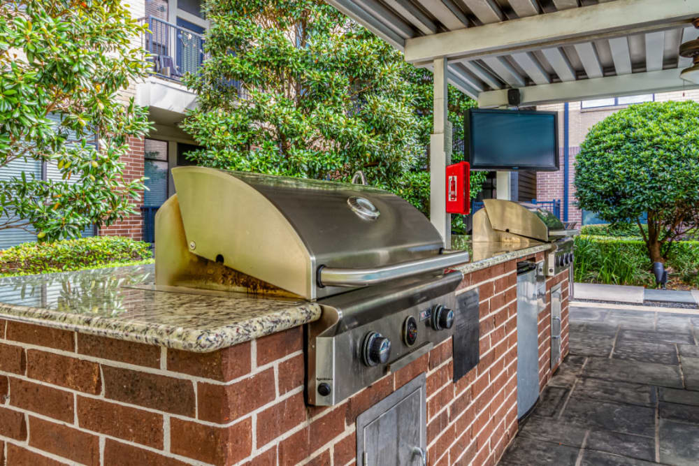 BBQ grills set in brick with granite countertop at The Marq on Voss in Houston, Texas