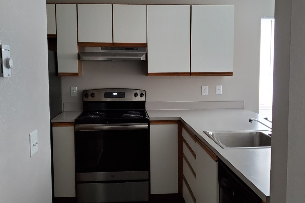 Kitchen with stainless steel appliances at Valley Commons Apartments in Marysville, Washington