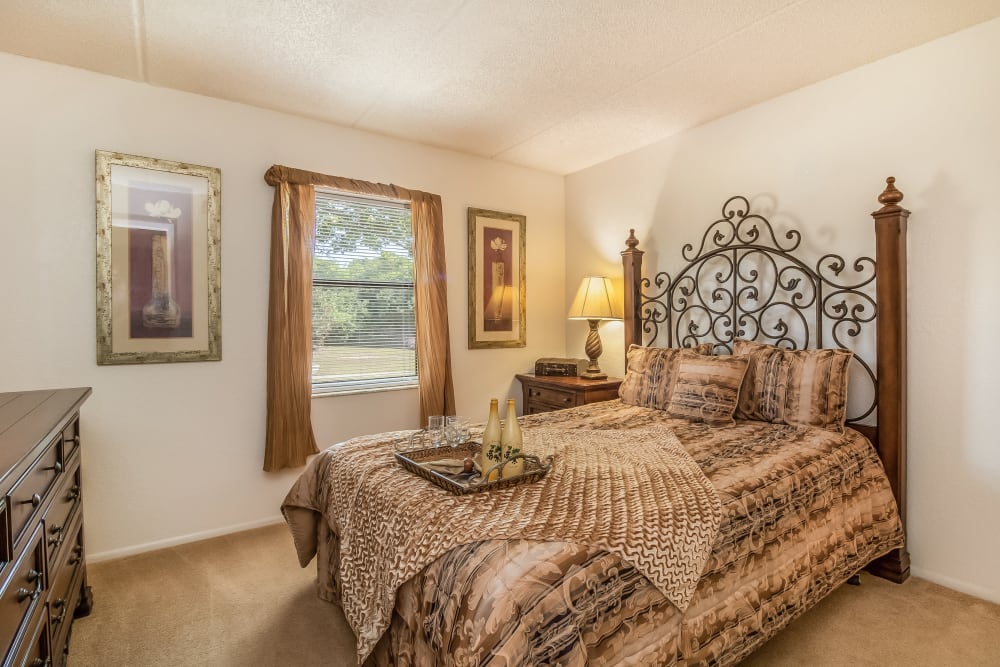 A furnished bedroom in a home at Melrose on the Bay Apartment Homes in Clearwater, Florida