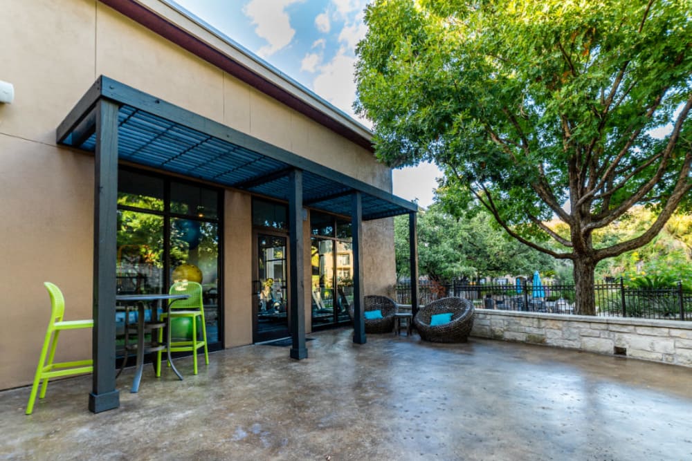 Outdoor seating wicker chairs and tall table and chairs at Marquis at Great Hills in Austin, Texas