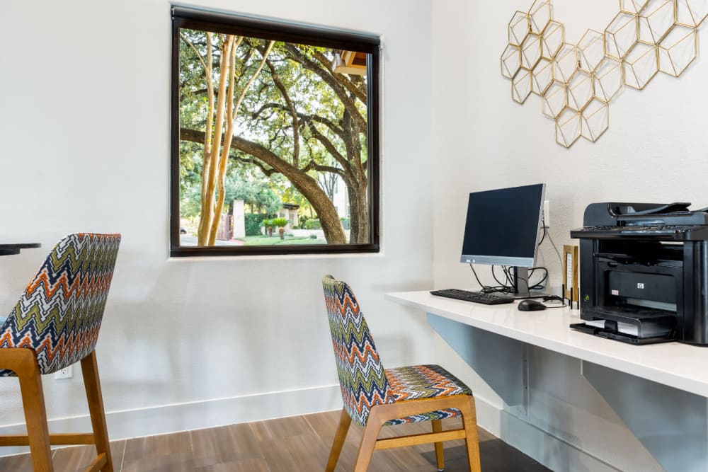 Computer workstation with printer next to window at Marquis at Great Hills in Austin, Texas