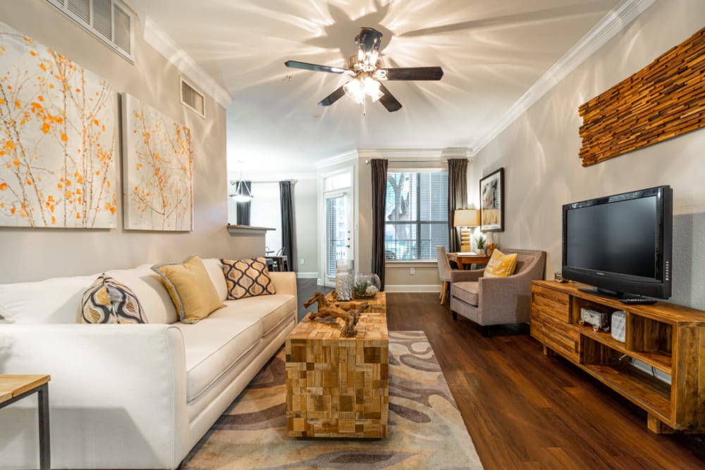 Modern style living room with wood flooring at Marquis at Great Hills in Austin, Texas