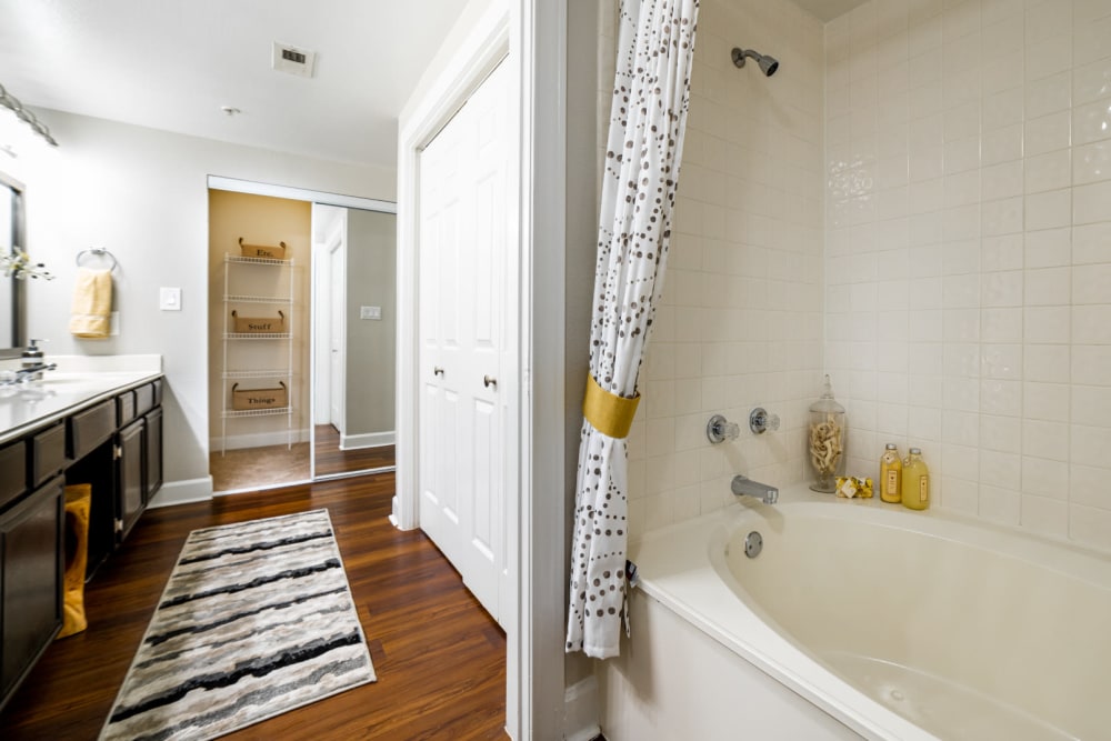 Bathtub and linen closet in bright bathroom at Marquis at Great Hills in Austin, Texas