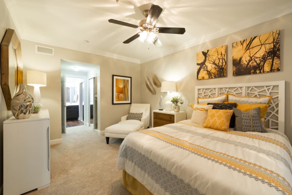 Spacious and bright bedroom with full size bed and sitting area at Marquis at Great Hills in Austin, Texas