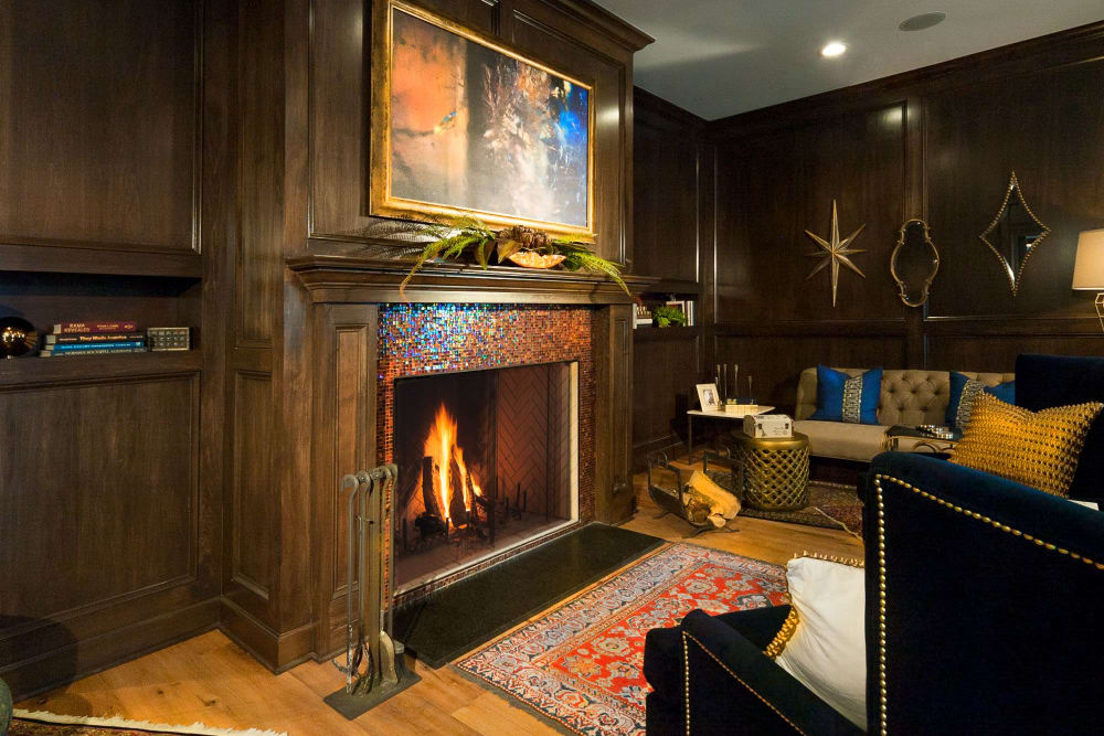 Fireplace with comfortable seating and art at Clifton Park Apartment Homes in New Albany, Ohio