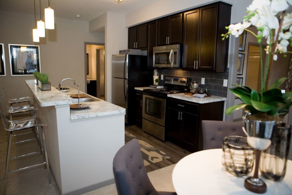 Side view of bar seating area and community kitchen at Palmer House Apartment Homes in New Albany, Ohio