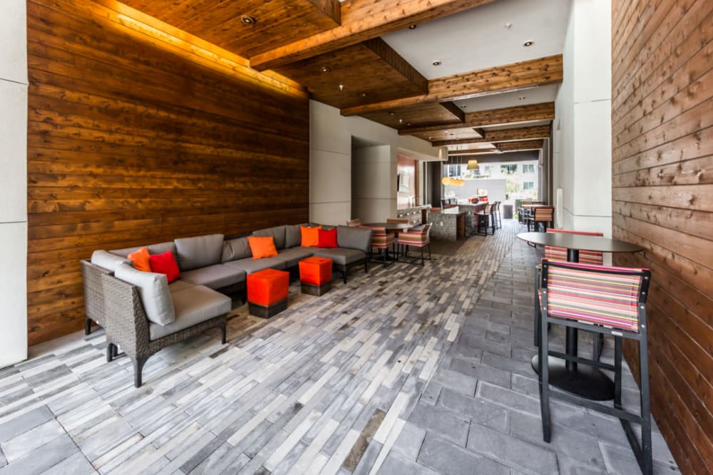 Thruway with lounge couches and dining bar tables and chairs at Marq on Burnet in Austin, Texas