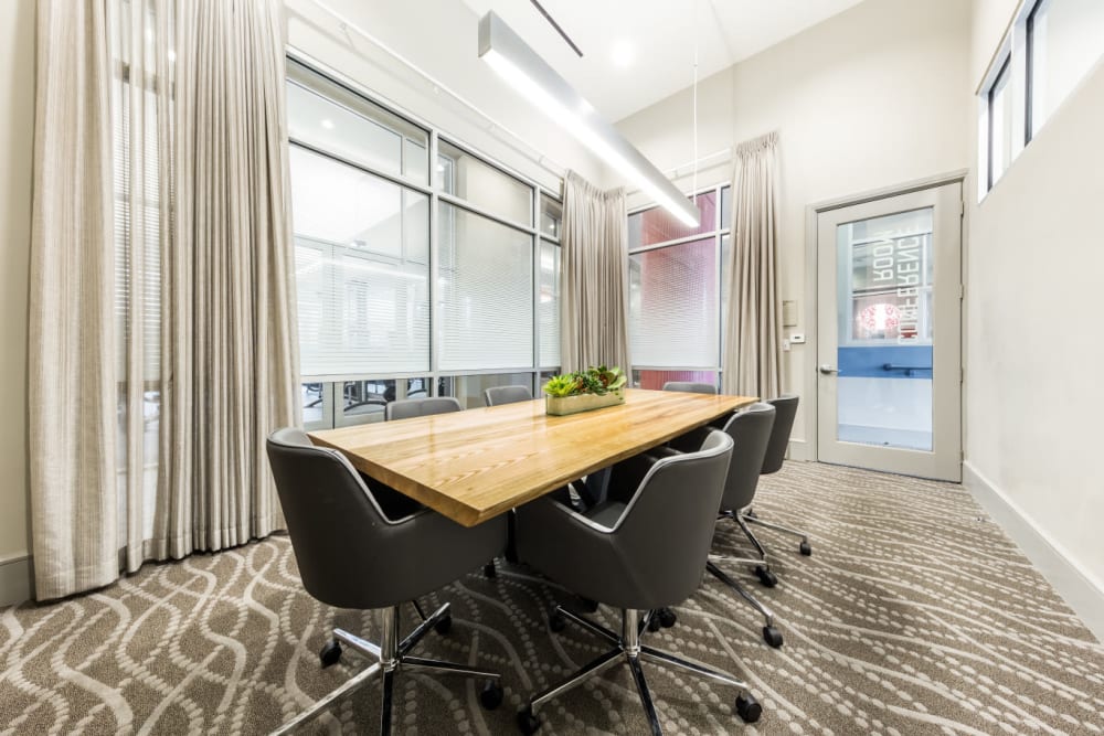 Private meeting room with large table and roller chairs at Marq on Burnet in Austin, Texas