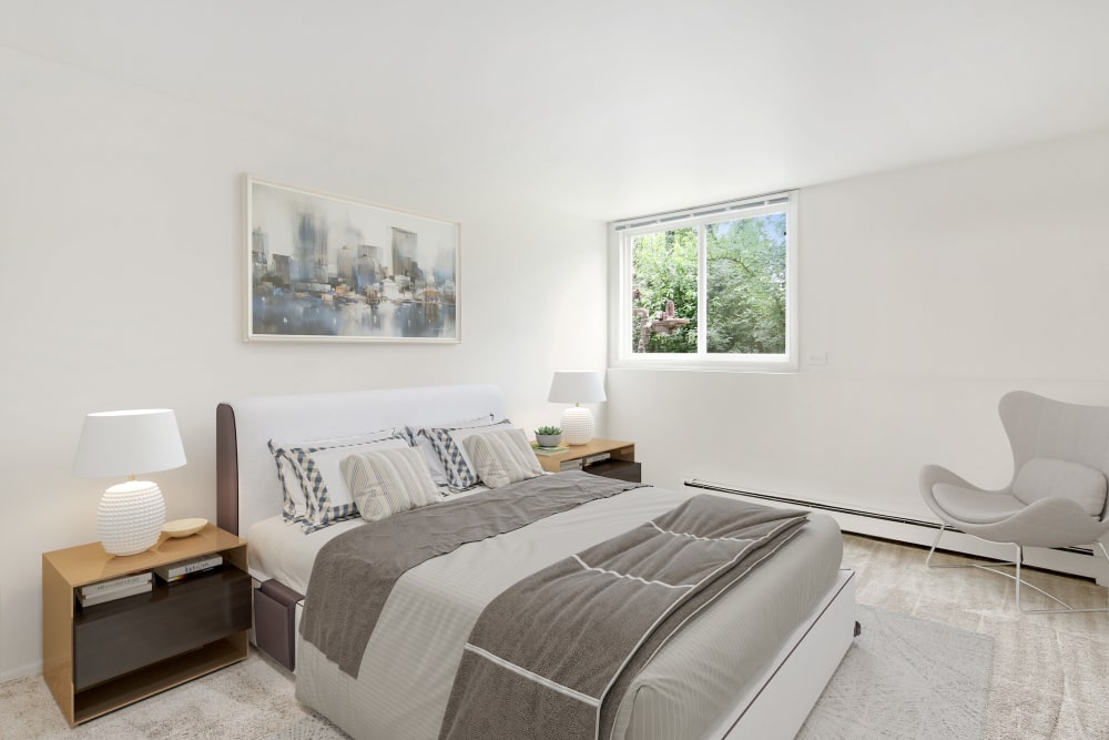 A furnished, brightly lit bedroom at Riverstone Apartments in Bolingbrook, Illinois