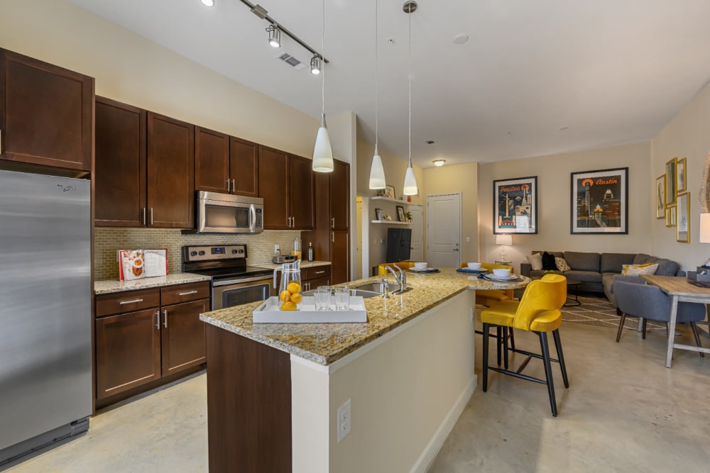 Spacious and open floor plan with kitchen, dining, desk, and living room areas at The 704 in Austin, Texas