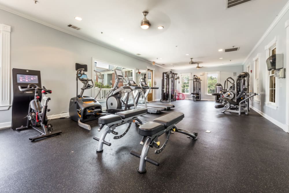 Cardio machines, benches, and assisted weight machines in fitness room at The Marq at Brookhaven in Atlanta, Georgia