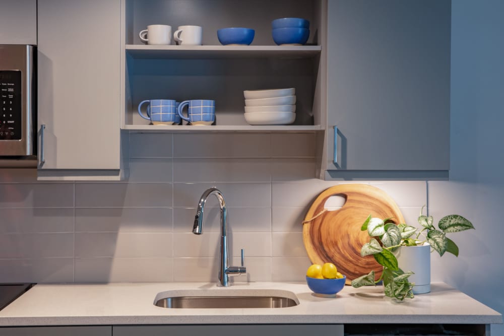 Beautiful quartz countertop in a model apartment's kitchen at Thirteen15 in New Orleans, Louisiana