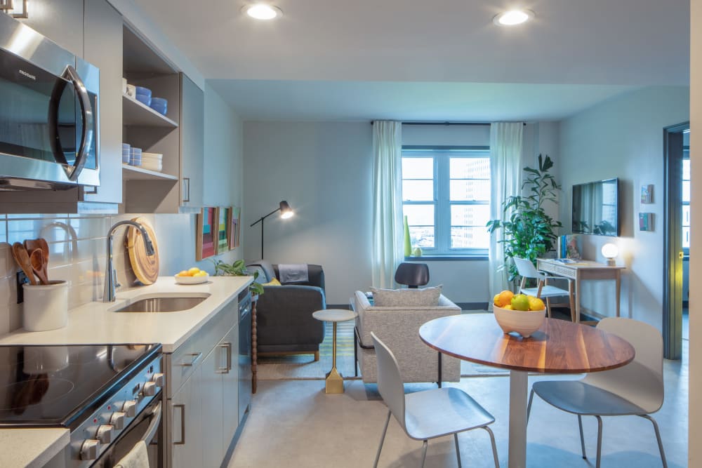 Open-concept kitchen with a view of the living area in a model apartment at Thirteen15 in New Orleans, Louisiana