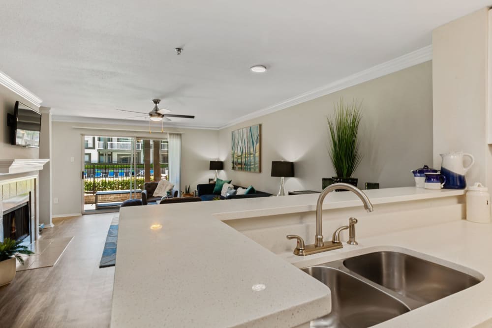 Massive kitchen and living room with gorgeous white countertops at 45Eighty Dunwoody Apartment Homes in Dunwoody, Georgia